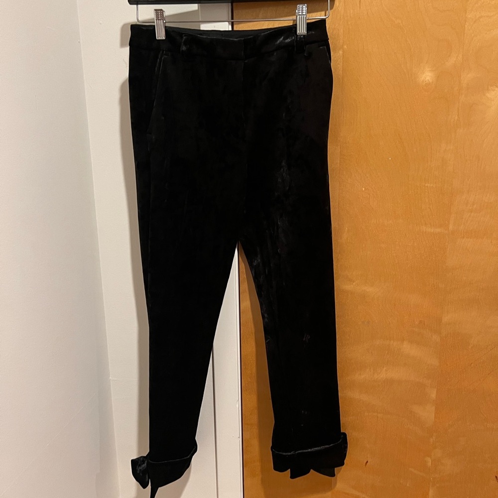 River Island black velvet pants with bow detail on the bottom of the back